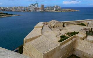 VALLETTA, MALTA - SEPTEMBER 14, 2012 View from the Valletta City Gate bridge to Valletta Ditch and St. John's Bastion in Valletta, Malta photo