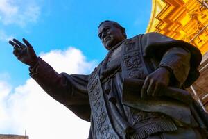 GOZO, MALTA - SEPTEMBER 14, 2012 Statue of Papa Piju IX in front of the Cathedral within the citadel in Cathedral Square, Victoria photo