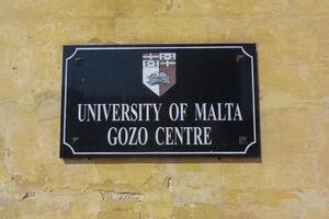 GOZO, MALTA - SEPTEMBER 14, 2012 plaque on the wall, Gozo Campus - University of Malta photo