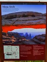 UTAH, USA - MAY 09, 2018 - information sign -Mesa Arch- on a background of mountains in Colorado, US photo