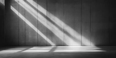 A sturdy concrete wall and smooth floor create an ideal backdrop for showcasing striking light and shadow patterns, perfect for captivating product displays or engaging presentations photo