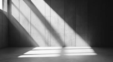 This minimalistic concrete space highlights striking light and shadow patterns, ideal for product displays and presentations, while offering ample space for additional information photo
