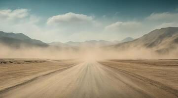 A long, winding gravel road stretches endlessly into the horizon, enveloped by an arid and rugged landscape of distant mountains and swirling clouds of dust, creating a captivating and tranquil scene photo