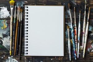This mockup features a sketchbook and paintbrushes, capturing the essence of artistic creativity and the multitude of project ideas it can inspire for both aspiring and seasoned artists photo