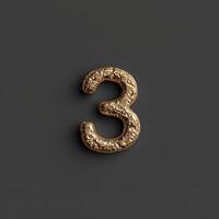 An artistic depiction of a golden number 3 featuring a textured design on a dark and contrasting background photo