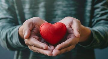 A warm and inviting image of hands gently cradling a vibrant red heart, symbolizing love and deep connection photo