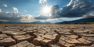 A vivid image illustrates the severe impact of prolonged drought with cracked earth under a bright sun, highlighting the significant challenges of climate change we must all confront photo