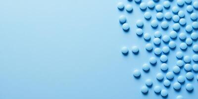 A scattered arrangement of blue pills on a soft blue surface, creating a calming and minimalist aesthetic. Ideal for healthrelated topics photo