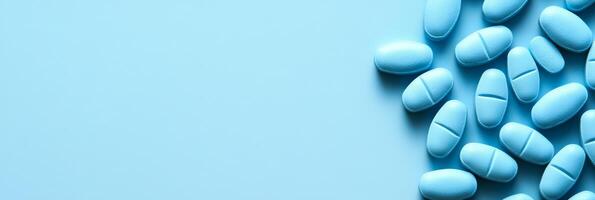 A visually captivating arrangement of small blue pills on a soft blue background highlights themes of pharmaceuticals and health, emphasizing the importance of medication for wellness and wellbeing photo