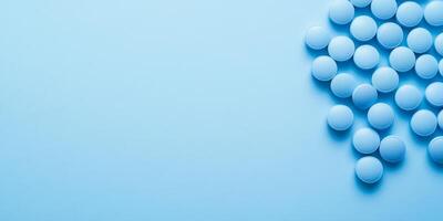 This image prominently features a carefully arranged collection of blue pills set against a soft blue background, effectively conveying various themes of health, healing, and overall wellness in life photo