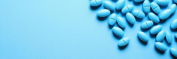 The visually appealing scene features a collection of blue pills artfully scattered on a soft blue background, making it perfect for discussions and presentations related to healthrelated topics photo