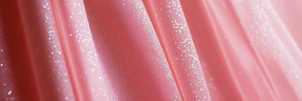 This delicate pink fabric has a shimmering texture, making it ideal for fashion and textile design projects photo