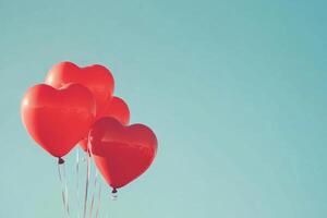 Heart-shaped balloons against a clear sky with text space. photo
