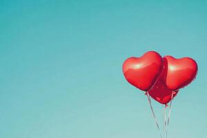 Heart-shaped balloons against a clear sky with text space. photo