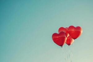 Heart-shaped balloons against a clear sky with text space. photo