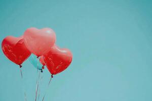 Heart-shaped balloons against a clear sky with text space. photo