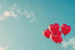 Heart-shaped balloons against a clear sky with text space. photo