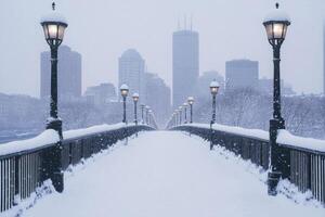 A city bridge covered in snow with the skyline in the background. photo