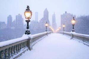 A city bridge covered in snow with the skyline in the background. photo