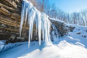 A frozen waterfall in a snow-covered landscape. photo