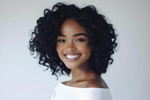 Young woman with sock curls smiling confidently in a white studio. photo