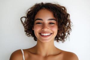 Smiling young woman with sock curls in a white studio. photo