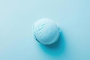 A top-down view of a light blue ice cream scoop on a light blue background. photo