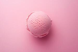 A top-down view of a pink ice cream scoop on a matching pink background. photo