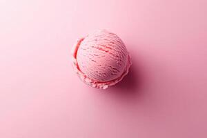 A top-down view of a pink ice cream scoop on a matching pink background. photo
