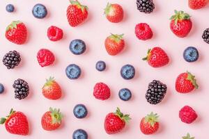 A fresh flat lay of spring berries like strawberries, blueberries, and raspberries. photo