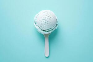 A top-down view of a light blue ice cream scoop on a light blue background. photo