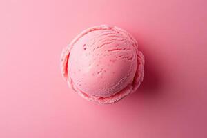 A top-down view of a pink ice cream scoop on a matching pink background. photo