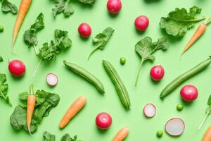 A selection of fresh spring vegetables on a bright green background. photo