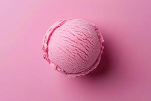 A top-down view of a pink ice cream scoop on a matching pink background. photo