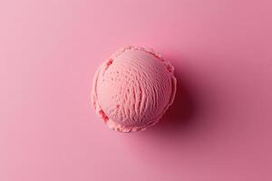 A top-down view of a pink ice cream scoop on a matching pink background. photo