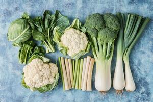 Crisp winter vegetables on a cool blue background. photo