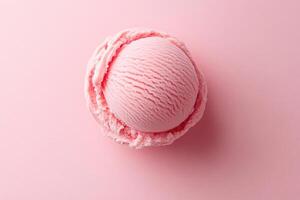 A top-down view of a pink ice cream scoop on a matching pink background. photo