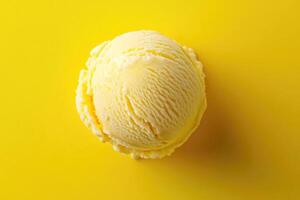 A top-down view of a yellow ice cream scoop on a matching yellow background. photo
