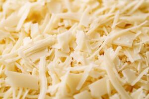 A textured layer of shredded cheese forms a rich, appetizing background. photo