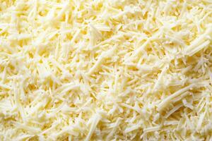 A textured layer of shredded cheese forms a rich, appetizing background. photo