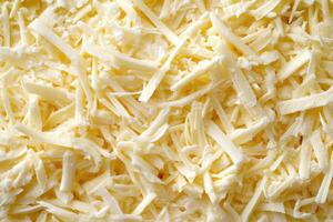 A textured layer of shredded cheese forms a rich, appetizing background. photo