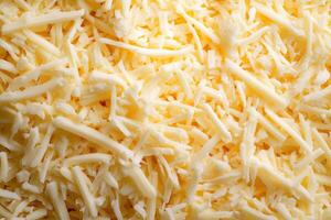 A textured layer of shredded cheese forms a rich, appetizing background. photo