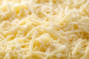 A textured layer of shredded cheese forms a rich, appetizing background. photo