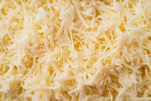 A textured layer of shredded cheese forms a rich, appetizing background. photo