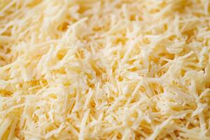 A textured layer of shredded cheese forms a rich, appetizing background. photo