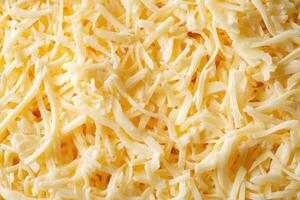 A textured layer of shredded cheese forms a rich, appetizing background. photo