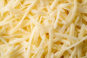 A textured layer of shredded cheese forms a rich, appetizing background. photo