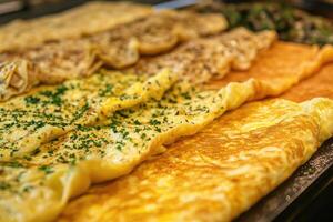 A rich array of French omelettes creates a savory, elegant background. photo