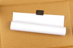 rolled empty sheet of paper on the Carton Background photo