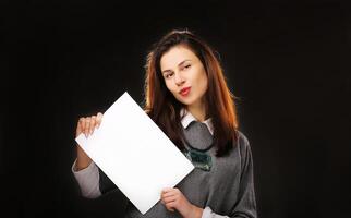 Woman holding an empty sheet of paper A4. Leaflet presentation. Pamphlet hold hands. Sheet template. Isolated over white background photo